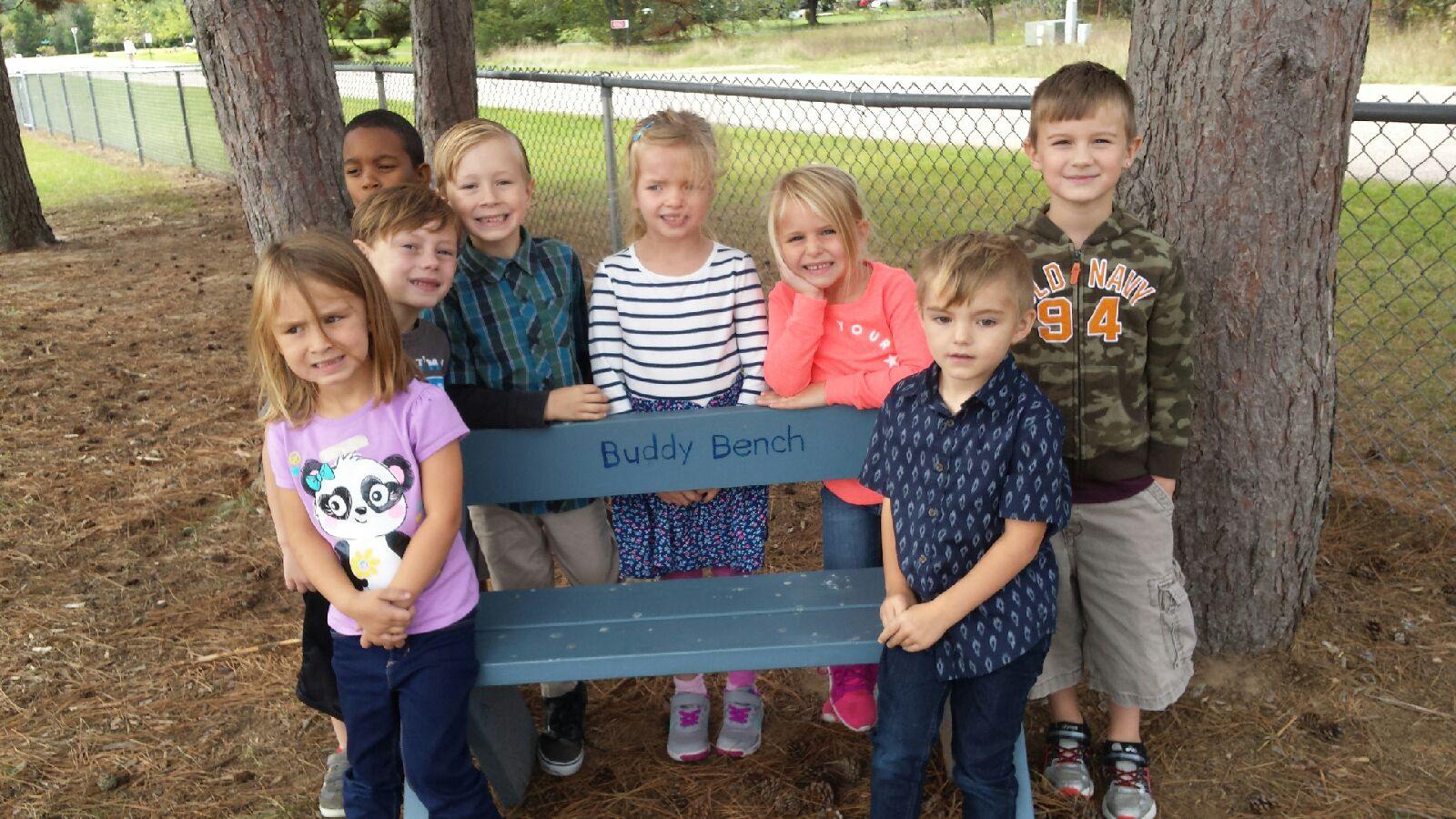 Students with buddy bench picture